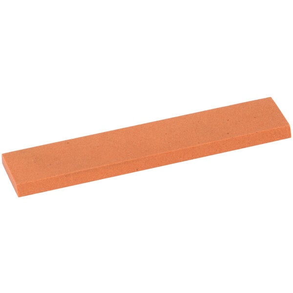 a rectangular orange block with a black handle