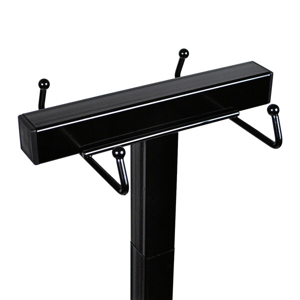 A black metal stand with three hooks for LK Packaging wet umbrella bags.