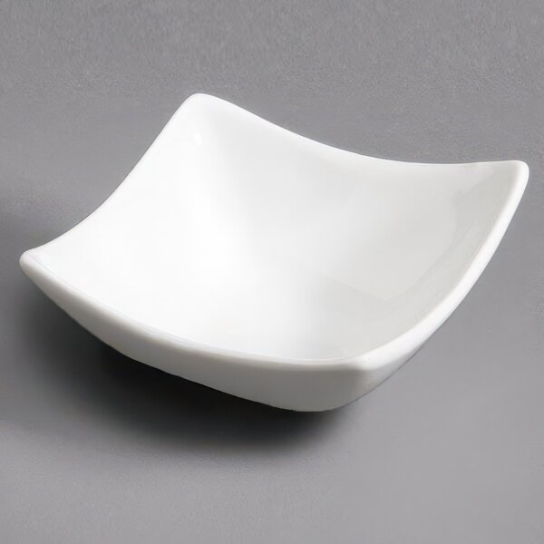 A CAC Super White Square Porcelain Dish with a small handle.