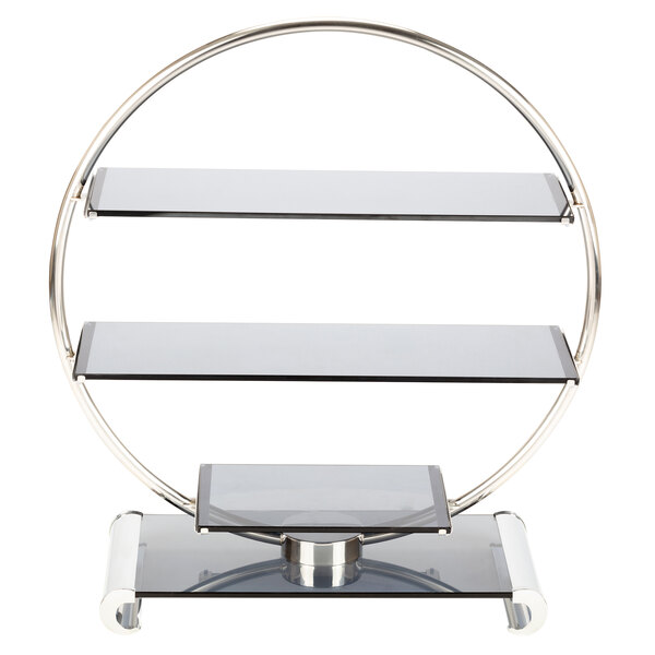 A Bon Chef stainless steel and glass wheel display stand with three glass shelves in a metal frame.