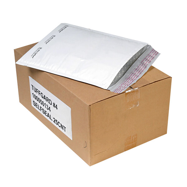 A brown box with a white label that reads "Jiffy TuffGard Self Seal Cushioned Mailers" containing white Jiffy TuffGard mailers.