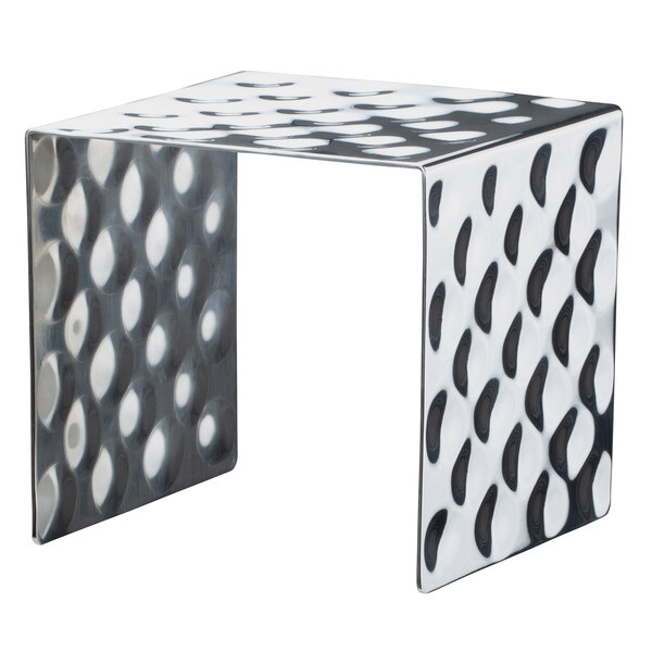 A Bon Chef stainless steel square showcase stand with a hammered surface on a metal table.