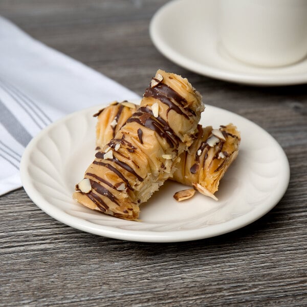 A Tuxton Meridian ivory china plate with chocolate covered pastries.