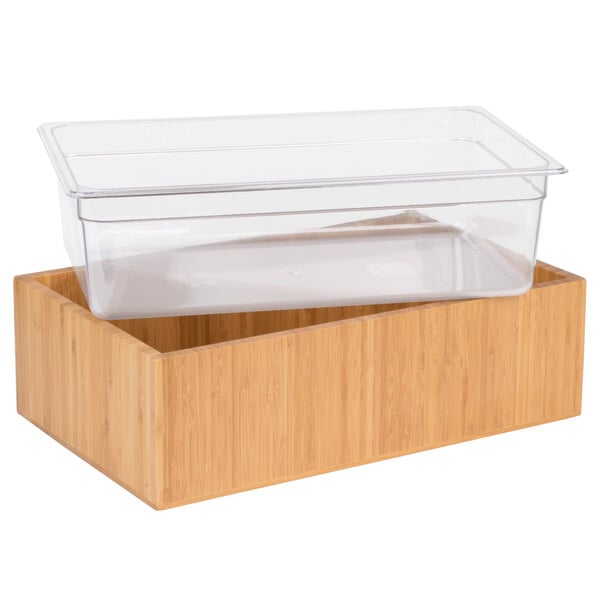 A clear plastic container in a bamboo ice housing.