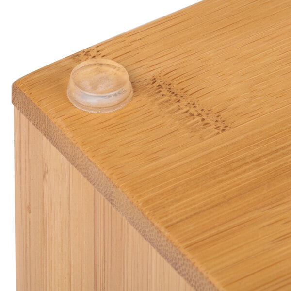 A Cal-Mil bamboo ice housing with clear pan on a wood surface.