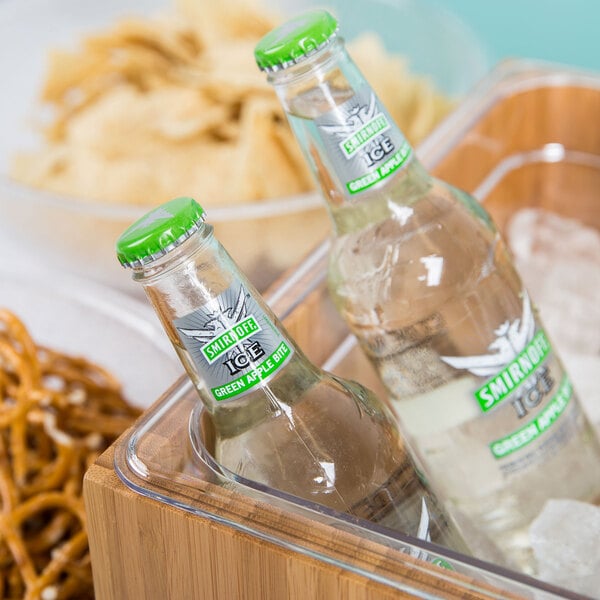 A Cal-Mil bamboo ice housing container holding two bottles of beer and ice.