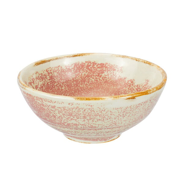 A white porcelain bowl with a speckled surface and a pink and gold rim.