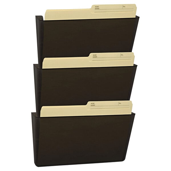 A smoke gray Storex wall file with three pockets holding black file folders.