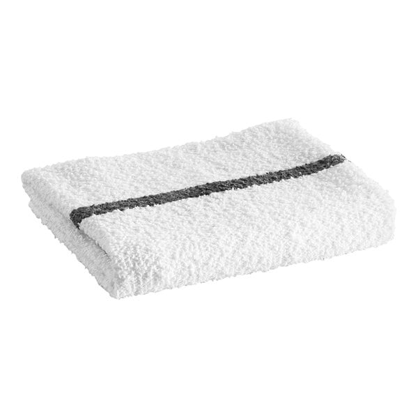 A folded white textured towel with a single black stripe running across it.