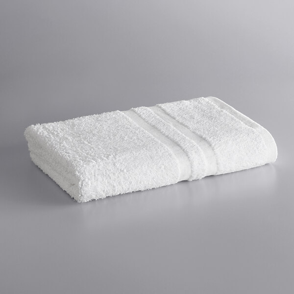 A white Lavex bath towel on a gray surface.