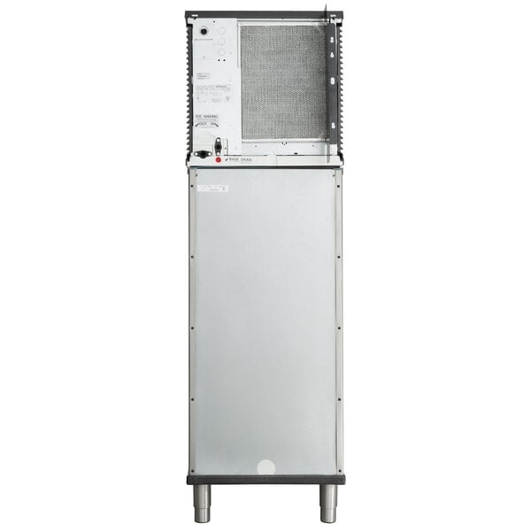 A black rectangular Manitowoc air cooled ice machine with a silver door open.