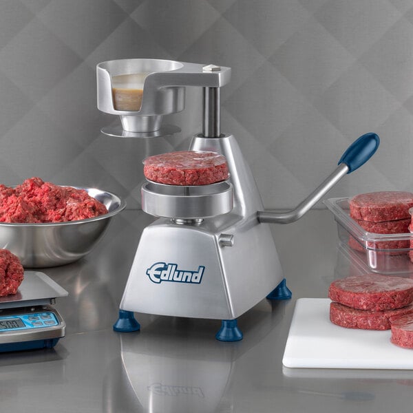 Edlund round cellophane patty paper with meat patties on a machine.