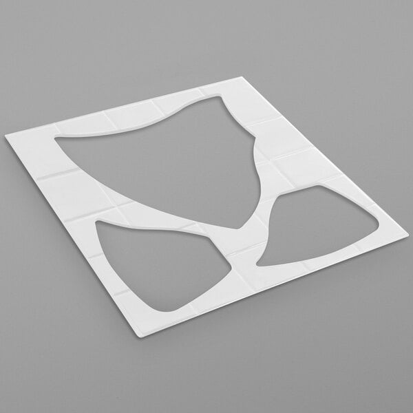 A white plastic stencil with a square cut out shape.