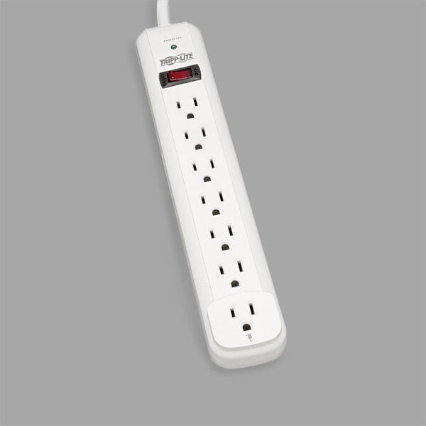 A close-up of a white Tripp Lite power strip with multiple outlets and a red light on it.