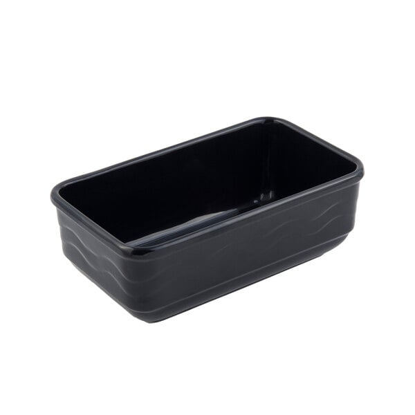 A black rectangular Bon Chef cast aluminum casserole with wavy lines on the edges.