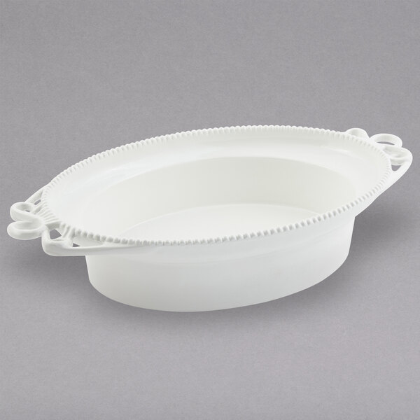 a white oval dish with a handle