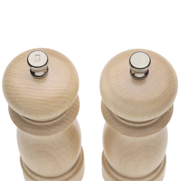 Two wooden salt and pepper mills with a metal cap.