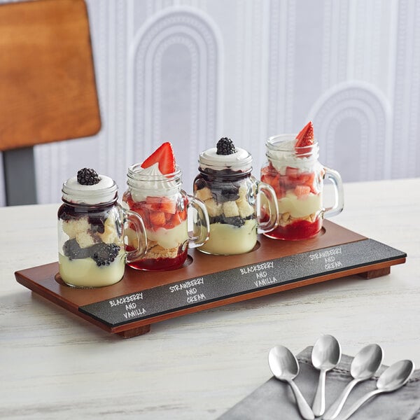 a glass jar with strawberries and whipped cream