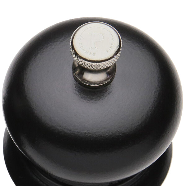 A black pepper mill and salt shaker set with silver knobs on a table.