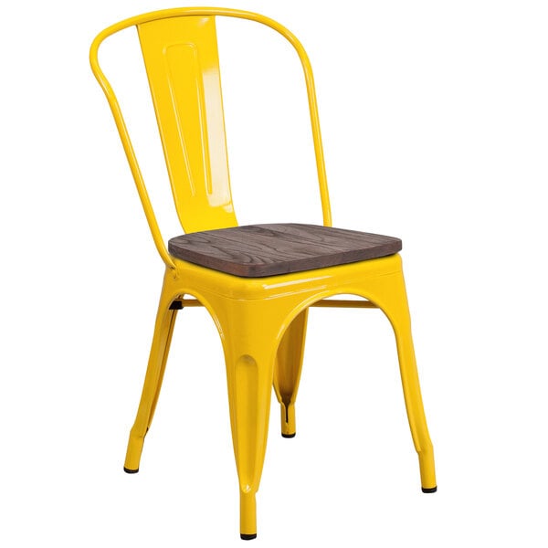 A yellow metal chair with a Flash Furniture wooden seat.