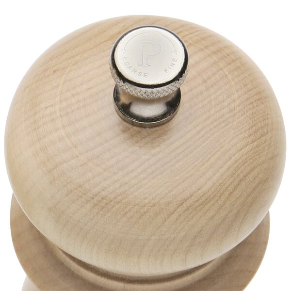 A wooden pepper mill with a silver top.