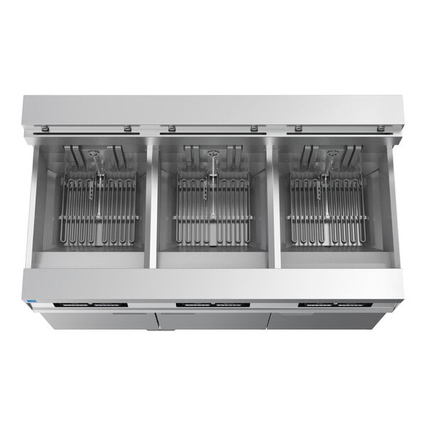 A commercial electric floor fryer with three separate frying units and built-in filtration system.