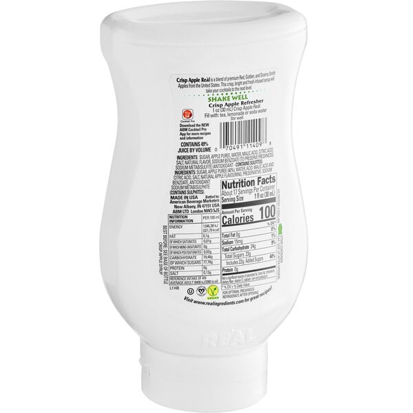 A white plastic bottle of Real Apple Puree Infused Syrup with a label with black and green text.