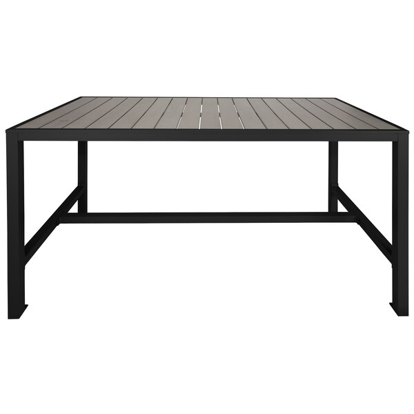 A BFM Seating black metal bolt-down table with a gray wooden top.