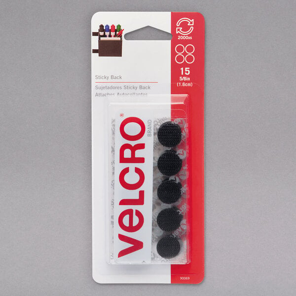 A package of 15 black Velcro® circles with sticky backs.