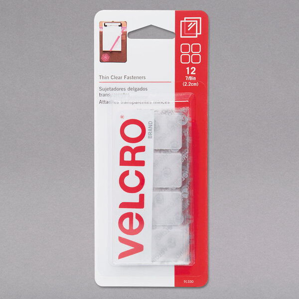 A package of Velcro® clear adhesive fasteners with red and white labels.