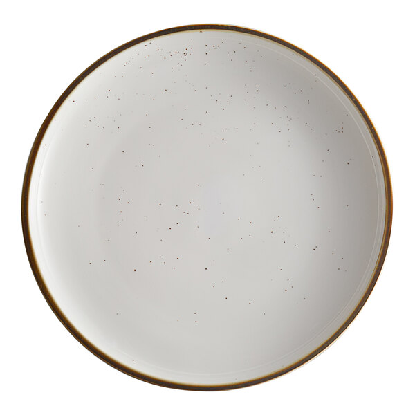 A white Acopa stoneware coupe plate with brown specks on the edges.
