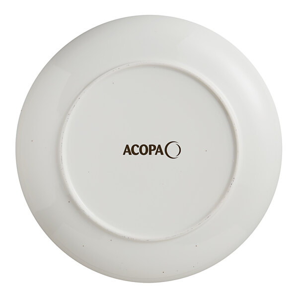 A white Acopa stoneware coupe plate with black text that says Keystone.