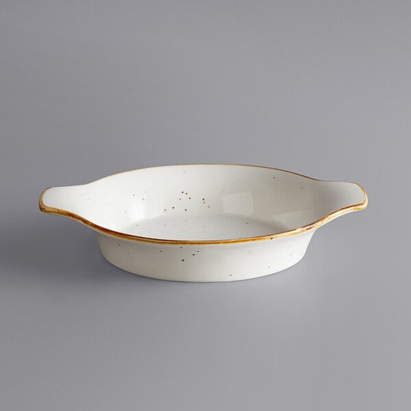 A white stoneware casserole dish with brown specks.