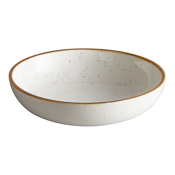 An Acopa Keystone stoneware coupe low bowl in white with brown specks.