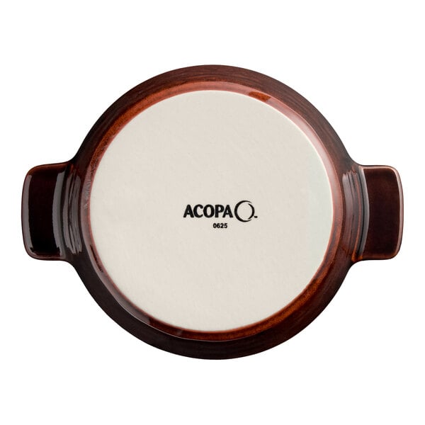 A small chestnut-colored porcelain casserole dish with handles, viewed from the bottom and labeled with the Acopa brand.