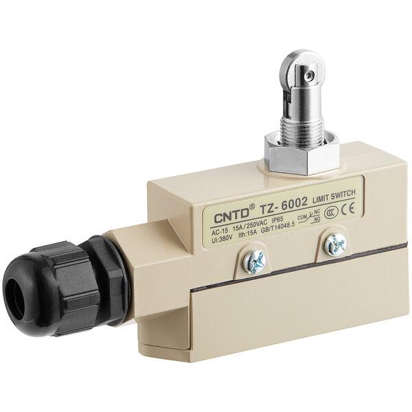 A close-up of a small, white, metal Curtron roller door plunger switch.