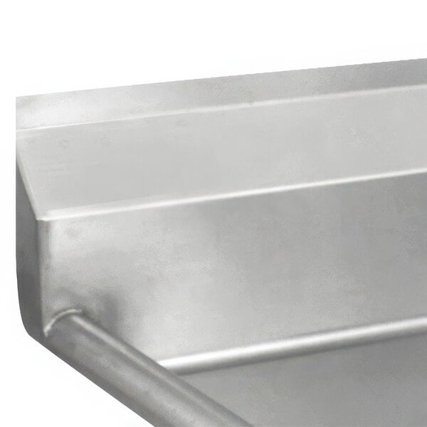 A close up of an Advance Tabco fabricated one compartment pot sink with a left drainboard.