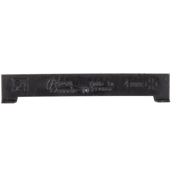 A black plastic Bron Coucke cutting blade with writing on it.