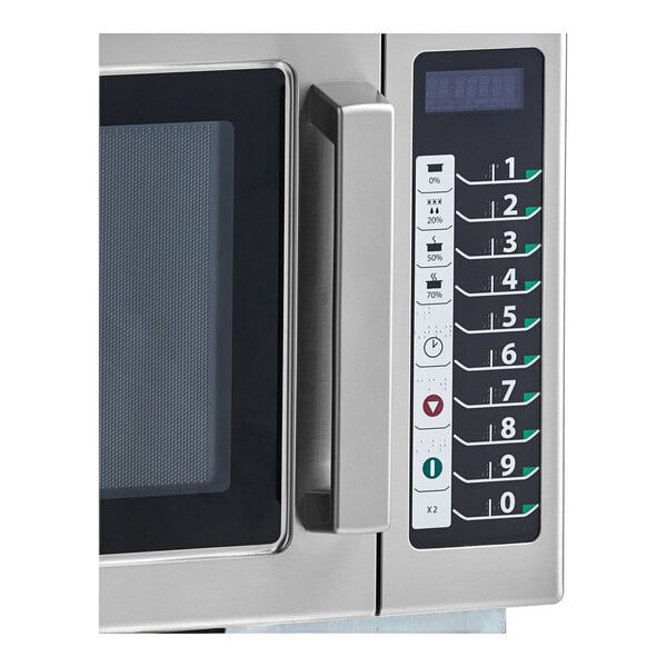 An Amana commercial microwave with push button controls and a digital display.