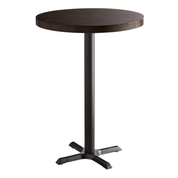 A Lancaster Table & Seating round table with a wooden top and black base plate.