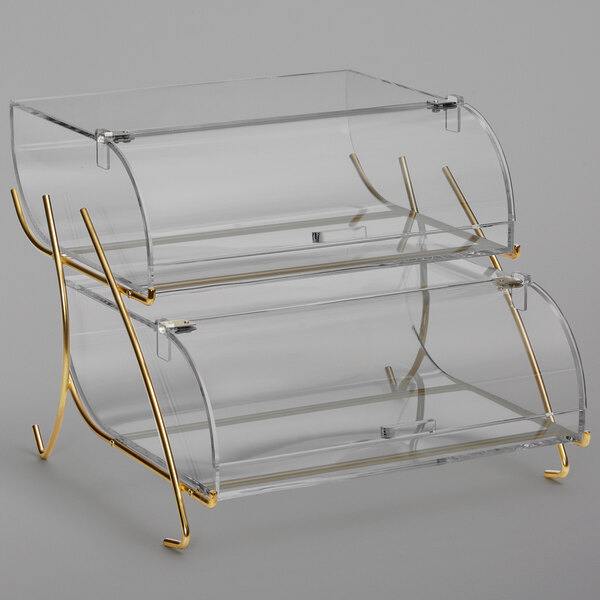 a clear glass display case with gold legs