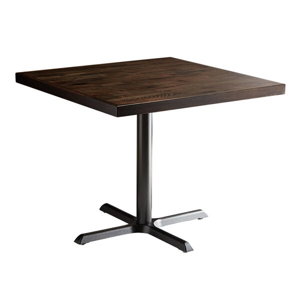 A Lancaster Table & Seating square wood table with espresso finish and cast iron base plate.