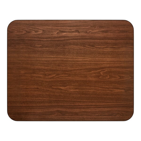 A rectangular, reversible dining table top with a walnut wood finish and rounded corners.