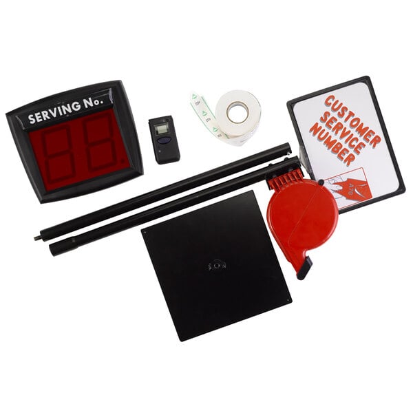 A Garvey My Turn digital take-a-number kit on a counter with a red and black sign.