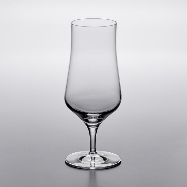 A close-up of a clear Stolzle stemmed beer glass.