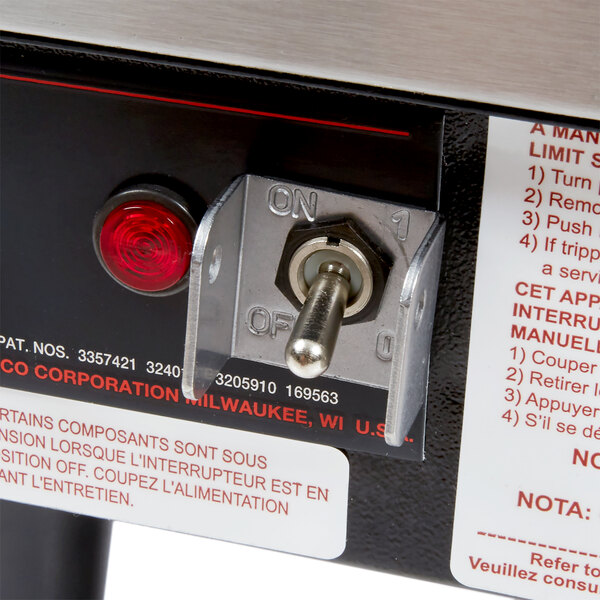 A close-up of a switch on a Hatco booster water heater.