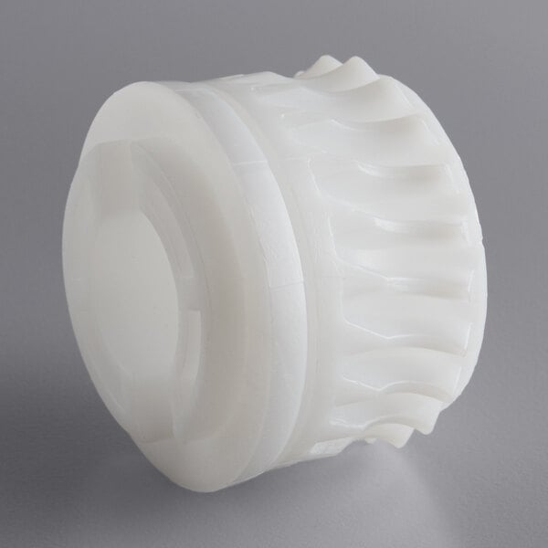 A white plastic gear wheel.