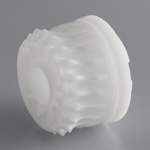 A close-up of a white plastic wheel with a circular design.