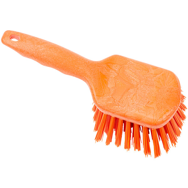 An orange Carlisle Sparta pot scrub brush with a handle.