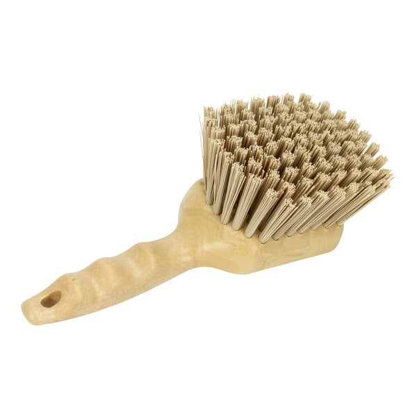 A Carlisle Sparta tan pot scrub brush with a wooden handle.